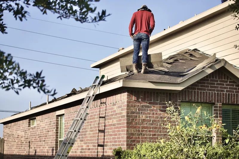 Professional roofer working on a residential roof in Downers Grove Park